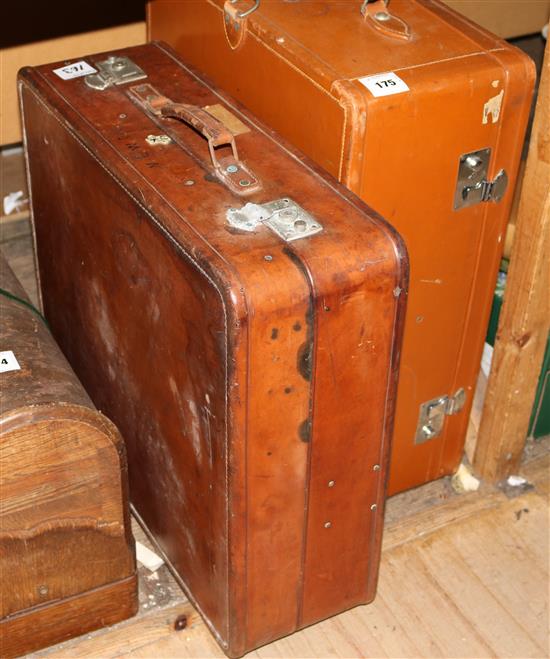 2 small brown leather cabin trunks